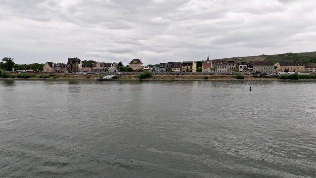 Traveling along the Rhine River with scenic views of the medieval town of Trebur, Germany. Views of colorful European style architecture and vineyards on the sloping land