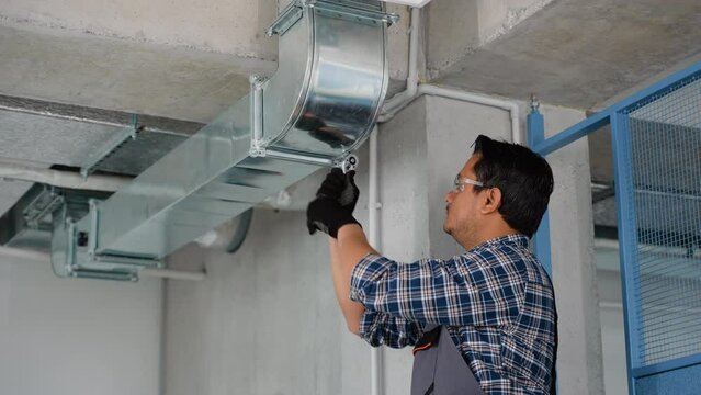 Hvac technician at work. Ventilation system installation and repair service
