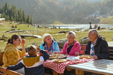 A family on a mountain vacation indulges in the pleasures of a healthy life, savoring traditional...