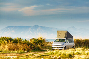 Van with roof top tent camping on nature