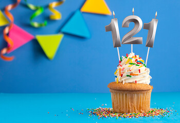 Birthday cake with candle number 121 - Blue background