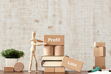 There is wood block with the word Profit or Loss. It is as an eye-catching image.