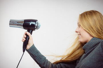 Woman holding hairdryer