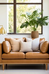 Minimalist living room interior with brown leather sofa and potted floor plant,
