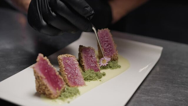 Cook plating tuna fish for hotel restaurant diners