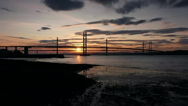 Sunset at Forth Bridge Scotland United Kingdom aerial panoramic view with scenic clouds