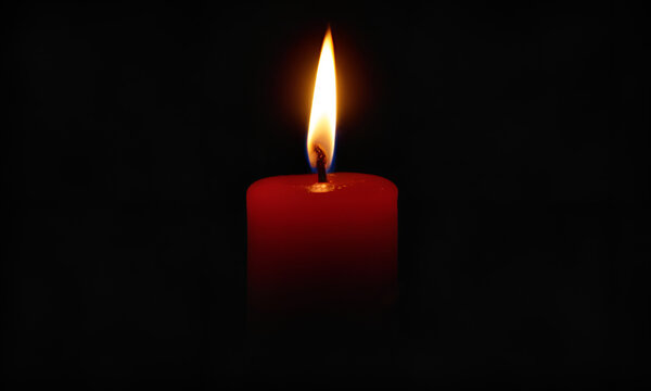 One very short red candle near the bottom of the image burning in total darkness