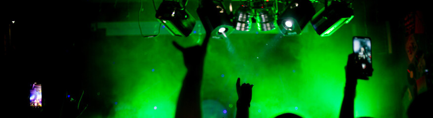 Nightlife and disco concept. Young people are dancing in club or outdoor in sunlight. Happiness, holidays, youth concepts. Female and male hands and silhouettes in smoke