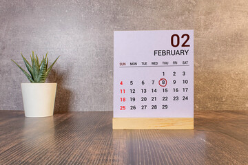 February 08. 8th day of the month, wooden calendar isolated on a white background with shadow