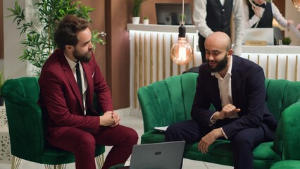 Associates shake hands in agreement, forging new future partnership between international...