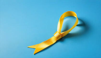 Childhood Cancer Awareness Yellow Ribbon on blue background with space for copy for world cancer day 4 feb concept created with generative ai - obrazy, fototapety, plakaty