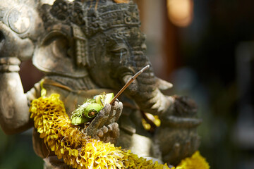 Sculpture of a temple with flowers and incense for ritual offerings on the popular tourist island of Bali.