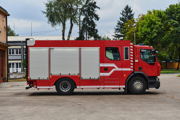 A state-of-the-art firetruck, equipped with advanced rescue technology, stands ready with its...
