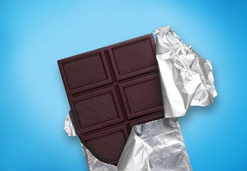 Tasty sweet milk chocolate bar on desk