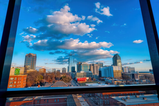 A framed sky view of a colorful city skyline of Raleigh, North Carolina buildings in HDR near sunset.