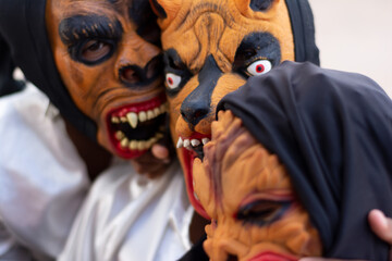 People are seen wearing horror costumes and masks in the Acupe district in the city of Santo Amaro,...