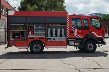 Foto op Canvas A state-of-the-art firetruck, equipped with advanced rescue technology, stands ready with its skilled firefighting team, prepared to intervene and respond rapidly to emergencies, ensuring the safety © .shock