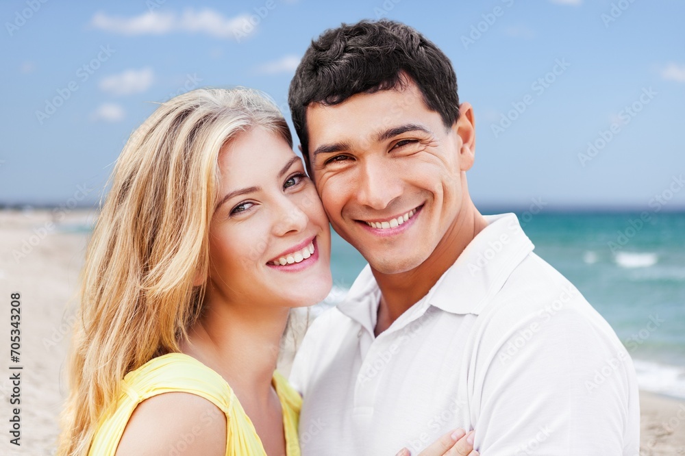 Sticker Young diverse couple have fun together at the beach