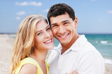 Young diverse couple have fun together at the beach