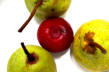pears and plum. three pears with a plum in the center. green and red fruits. fruit colors.