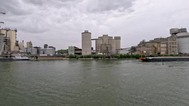 Factory Scene with Industrial Building and Equipment on the Rhine River. Large silo towers in the center of view.  Located just south of Mainz, Germany in Bleiau, Germany.