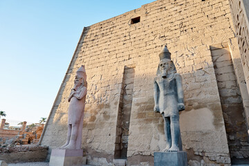 Seated statue of Ramesses II by the Luxor Temple entrance, sunset scenery, Egypt.Luxor Temple main...