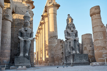 Seated statue of Ramesses II by the Luxor Temple entrance, sunset scenery, Egypt.Luxor Temple main...
