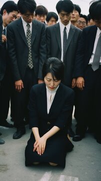 A woman is kneeling in front of a group of men