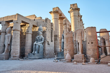 Seated statue of Ramesses II by the Luxor Temple entrance, sunset scenery, Egypt.Luxor Temple main...