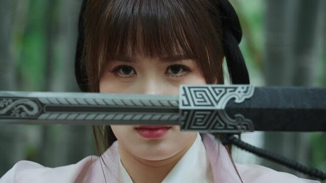 female drawing a sword