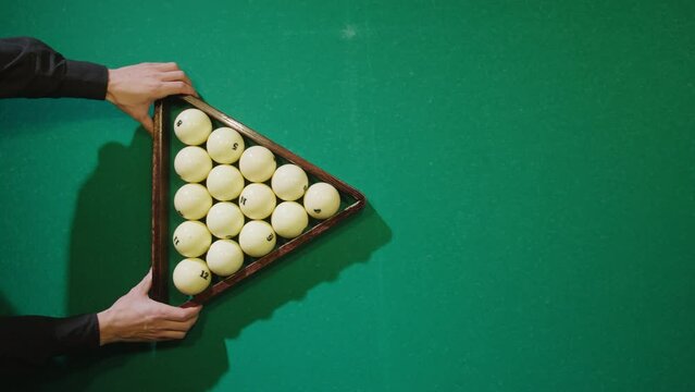 Breaking white pool balls top view on green billiards table for start to play. Russian biliard game, Russian pyramid. Billiard balls with numbers on a pool table. Billiards team sport.
