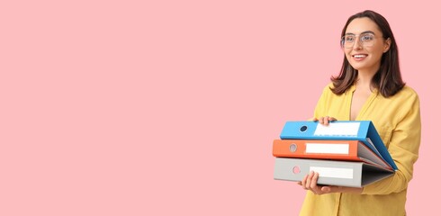 Young businesswoman with document folders on pink background with space for text