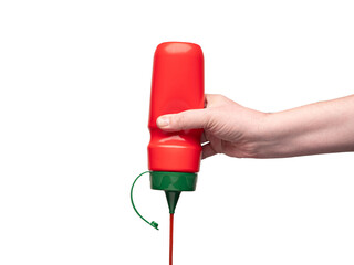 Hand with red plastic bottle squeezing ketchup out of it. No face, copy space.
