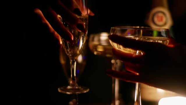 Pouring champagne into glasses at a celebration party in 4K