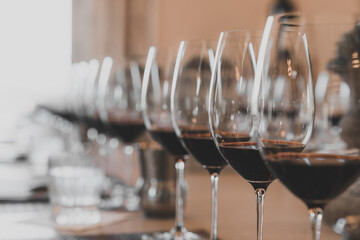 Red wine lined up in wine glasses