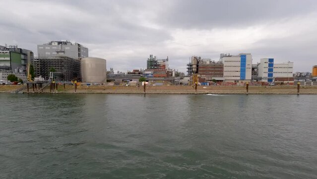 Factory Scene with Industrial Building and Equipment on the Rhine River. Large silo towers in the center of view.  Located just south of Mainz, Germany in Bleiau, Germany.
