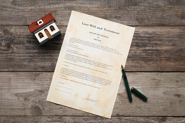 Last Will and Testament with fountain pen and house model on wooden table, top view