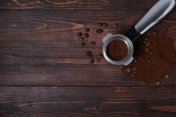 Scoop of coffee powder and beans on dark wooden background