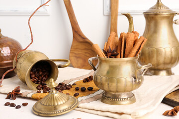 Composition with vintage tableware, cinnamon sticks and coffee beans on light table