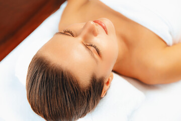 Closeup caucasian woman customer enjoying relaxing anti-stress spa massage and pampering with...