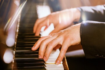 Human hands playing on the classic piano instrument