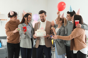 Group of business people with Birthday cake at party in office