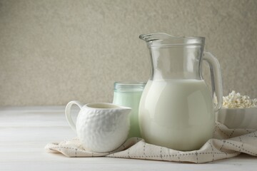 Lactose free dairy products on white wooden table, space for text