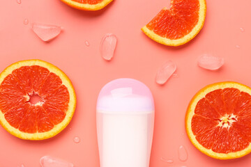 Deodorant with grapefruit slices and ice on orange background