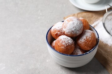 Delicious sweet buns in bowl on gray table, space for text