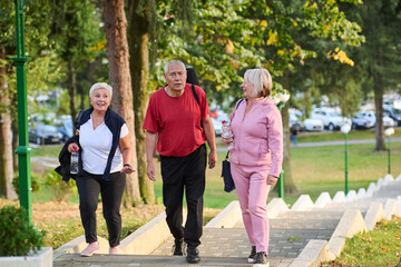A group of senior friends takes a well-deserved break in nature, fostering not only fitness but also camaraderie and a shared commitment to maintaining a healthy and active lifestyle in their golden