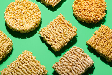 Raw instant noodles on green background