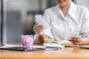 asian woman using calculator and calculate bills in home office. tax form us business income office...