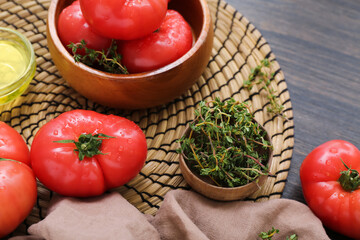 Bowl with fresh tomatoes on wooden background