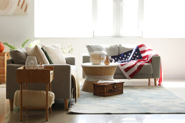 Interior of stylish living room with USA flag on sofa